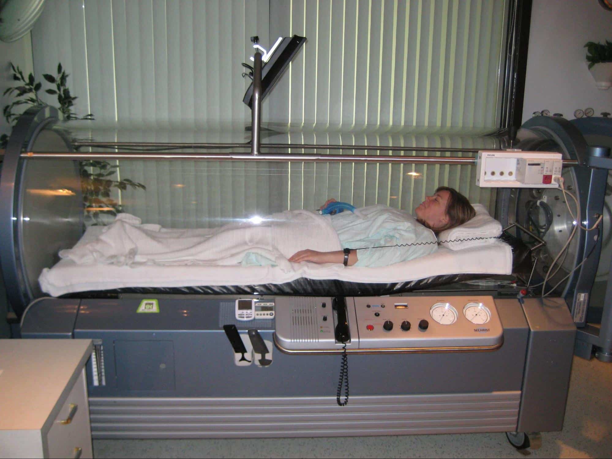 A woman inside a hyperbaric chamber