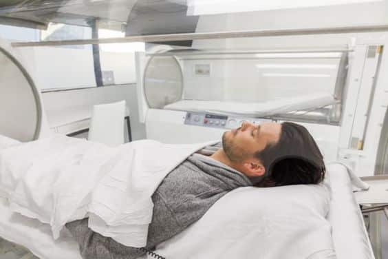 A patient inside a hyperbaric chamber