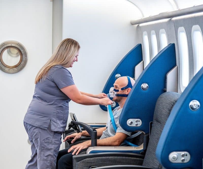 A healthcare provider attending a patient in hyperbaric care